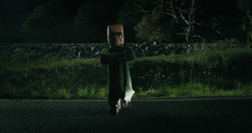 a person is flying through the air on a road at night