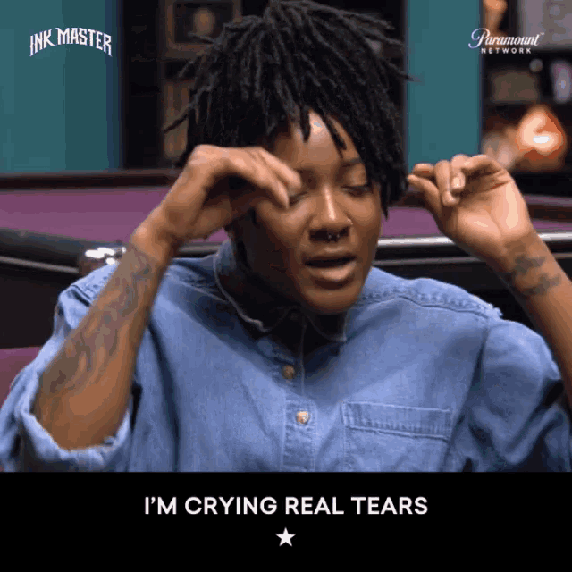 a woman with dreadlocks is crying with the words i 'm crying real tears