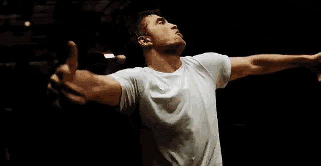 a man with his arms outstretched looks up into the sky