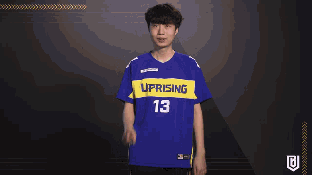 a man wearing a blue uprising jersey number 13