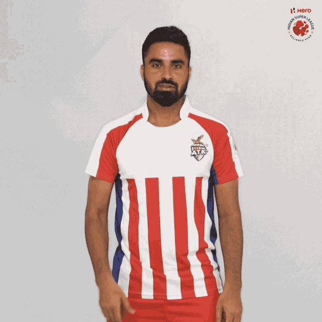 a man wearing a red white and blue striped shirt with the word hero on the front