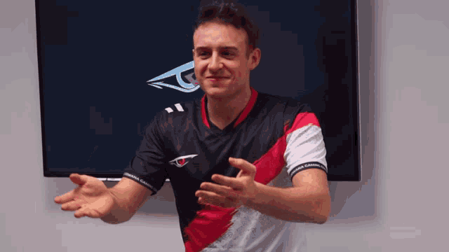 a man wearing a black and red shirt with a g on the front