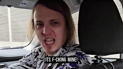 a man in a car with the words its f-cking mine written on the bottom