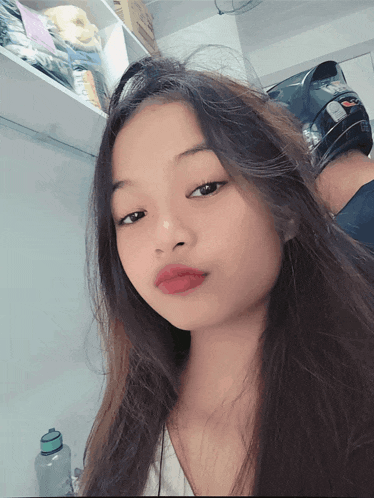 a girl with long hair is taking a selfie
