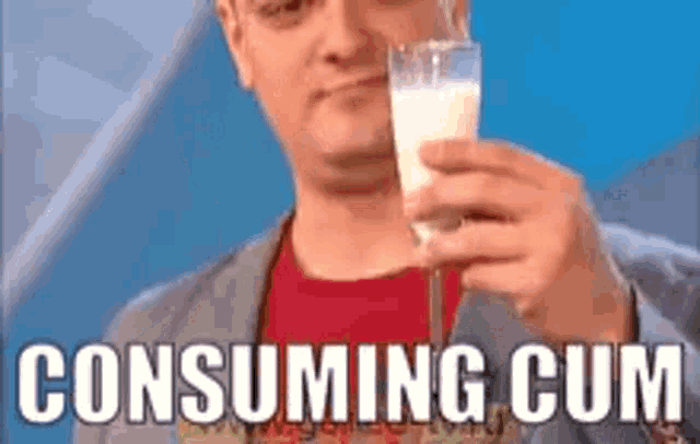 a man is holding a glass of milk with the words consuming cum on the bottom .