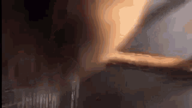 a close up of a person 's hand holding a piece of wood .
