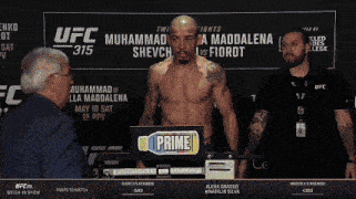 a man is standing in front of a sign that says ufc 315