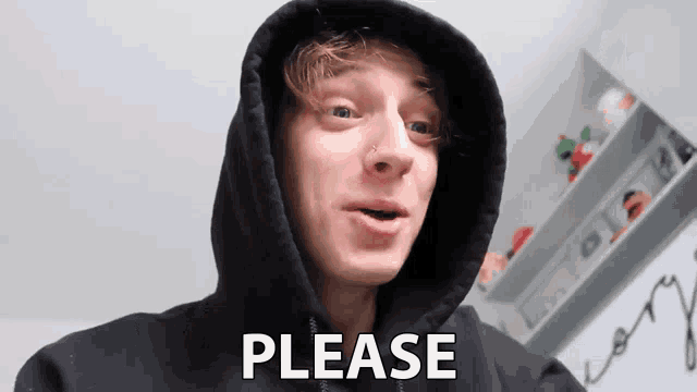 a man in a black hoodie is making a funny face and says please .