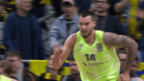 a basketball player wearing a yellow jersey with the number 14