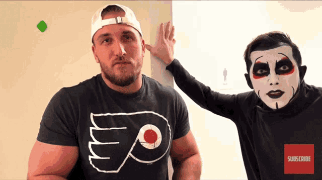 two men standing next to each other one wearing a shirt that says subscribe