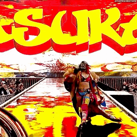a woman in a mask is walking down a ramp in front of a sign that says " sur "