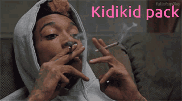 a man in a hoodie smoking a cigarette with the words kidikid pack written above him