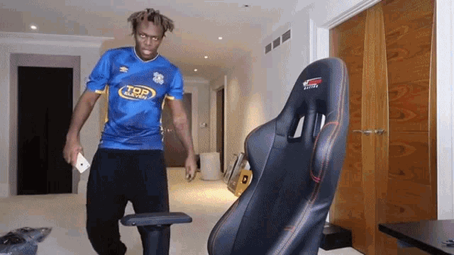 a man wearing a blue shirt that says top sports