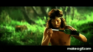 a shirtless man is holding a bottle of green liquid in a jungle .