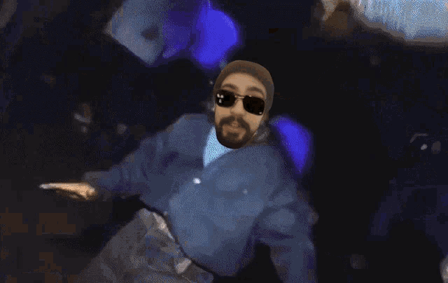 a man in a blue jacket and sunglasses is dancing