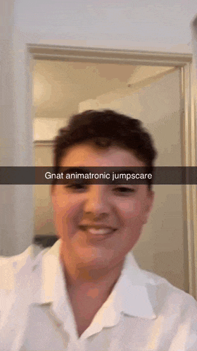 a man in a white shirt is smiling with a caption that says gnat animatronic jumpscare