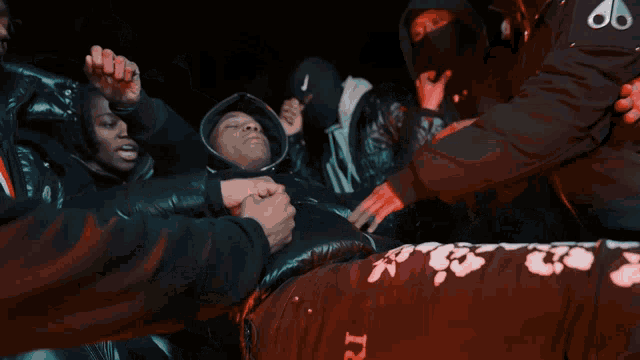 a group of people holding hands with one wearing a black jacket that says y3 on it