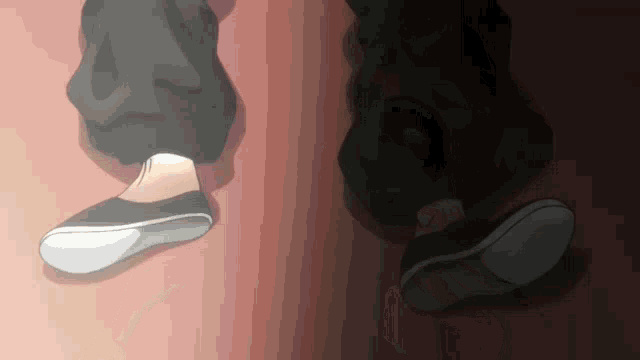 a person 's feet are shown walking on a pink floor