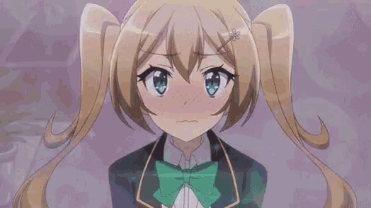 a girl with pigtails and a green bow tie is making a funny face .