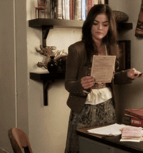 a woman is holding a piece of paper that says ' i 'm sorry ' on it