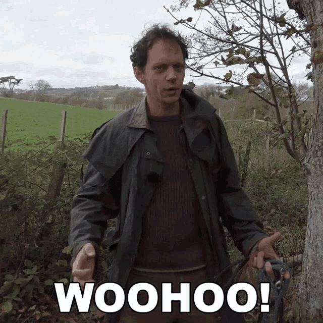 a man standing next to a tree with the word woohoo written on the bottom