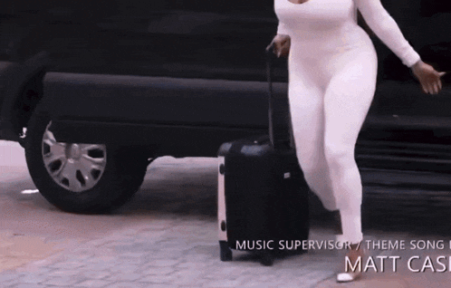 a woman carrying a suitcase in front of a car with the words music supervisor theme song matt cash written on the bottom