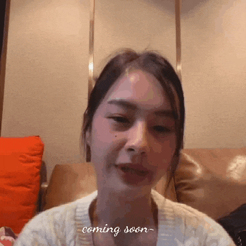 a woman is sitting on a couch with the words " coming soon " written on the bottom