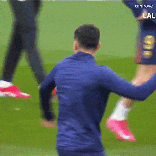a man in a blue shirt with the number 8 on his shorts