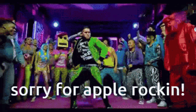 a man in a green suit is dancing in front of a crowd with the words sorry for apple rockin written below him