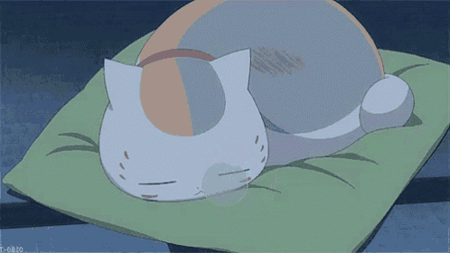 a cartoon cat is sleeping on a green pillow with a x on its face