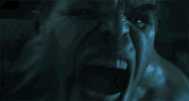 a close up of a person 's face with their mouth open .