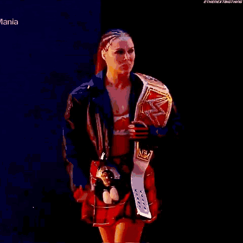 a woman in a plaid skirt is holding a world heavyweight wrestling championship belt