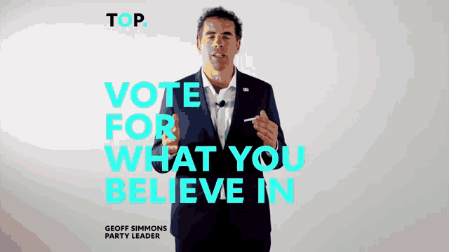 a man in a suit is standing in front of a sign that says " vote for what you believe in "