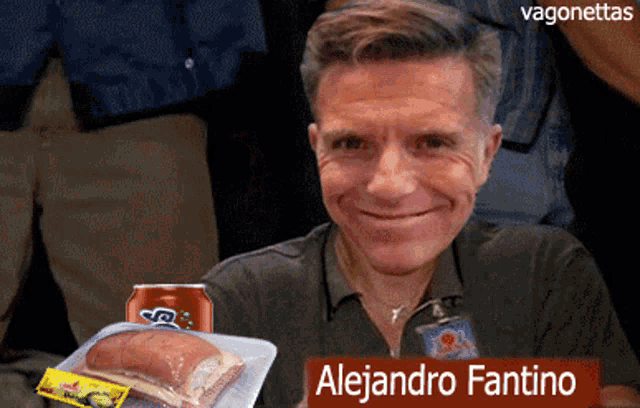 a man named alejandro fantino is smiling while holding a tray of food