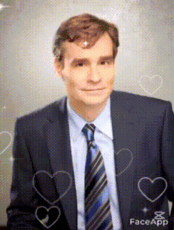 a man in a suit and tie with hearts around him