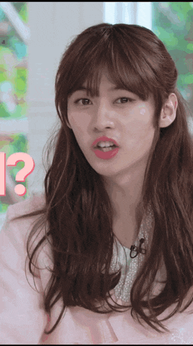 a woman in a pink jacket has a question mark in front of her