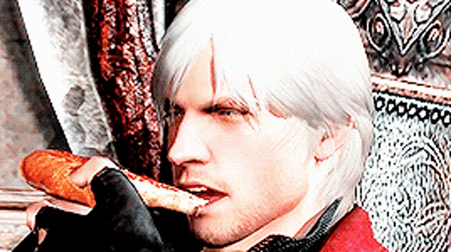 a man with white hair is eating a slice of bread