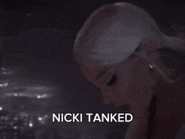 a picture of a woman sitting on a ladder with the words nicki tanked above her