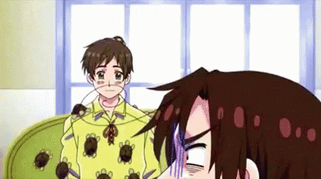 a couple of anime characters are sitting on a couch .