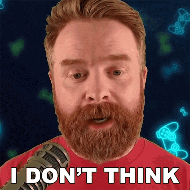 a man with a beard is talking into a microphone and says i don 't think