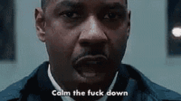 a close up of a man 's face with the words `` calm the fuck down '' written next to him .