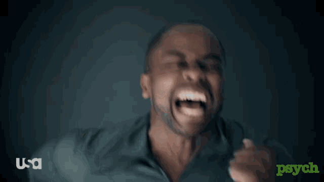a man with a beard is making a funny face with his mouth wide open .