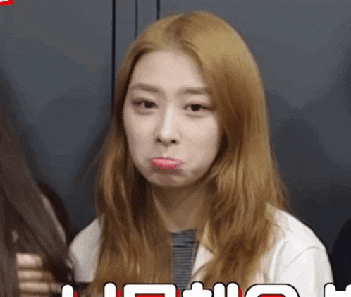 a woman with blonde hair making a funny face