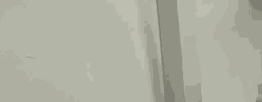a close up of a white wall with a few lines on it