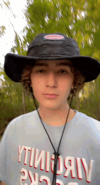 a young man wearing a hat and a t-shirt that says " timoray " on it