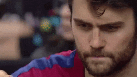 a close up of a man 's face with a beard