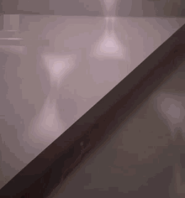 a close up of a staircase with a shadow of a person on it