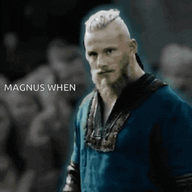 a man with a beard is standing in front of a crowd with the words magnus when written below him