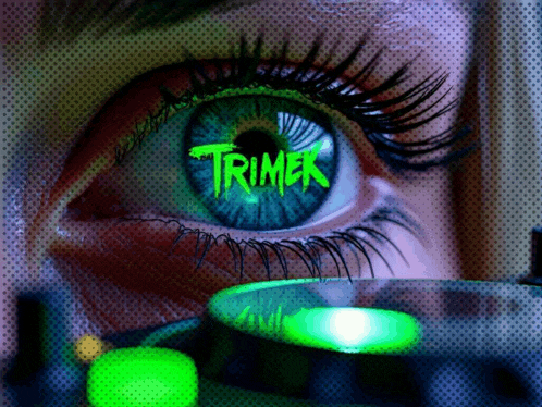 a close up of a woman 's eye with the word trimer in green