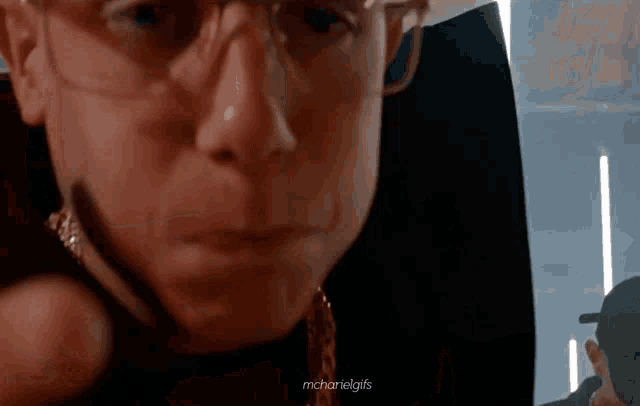 a close up of a man 's face with the words mchaniel gifs below it